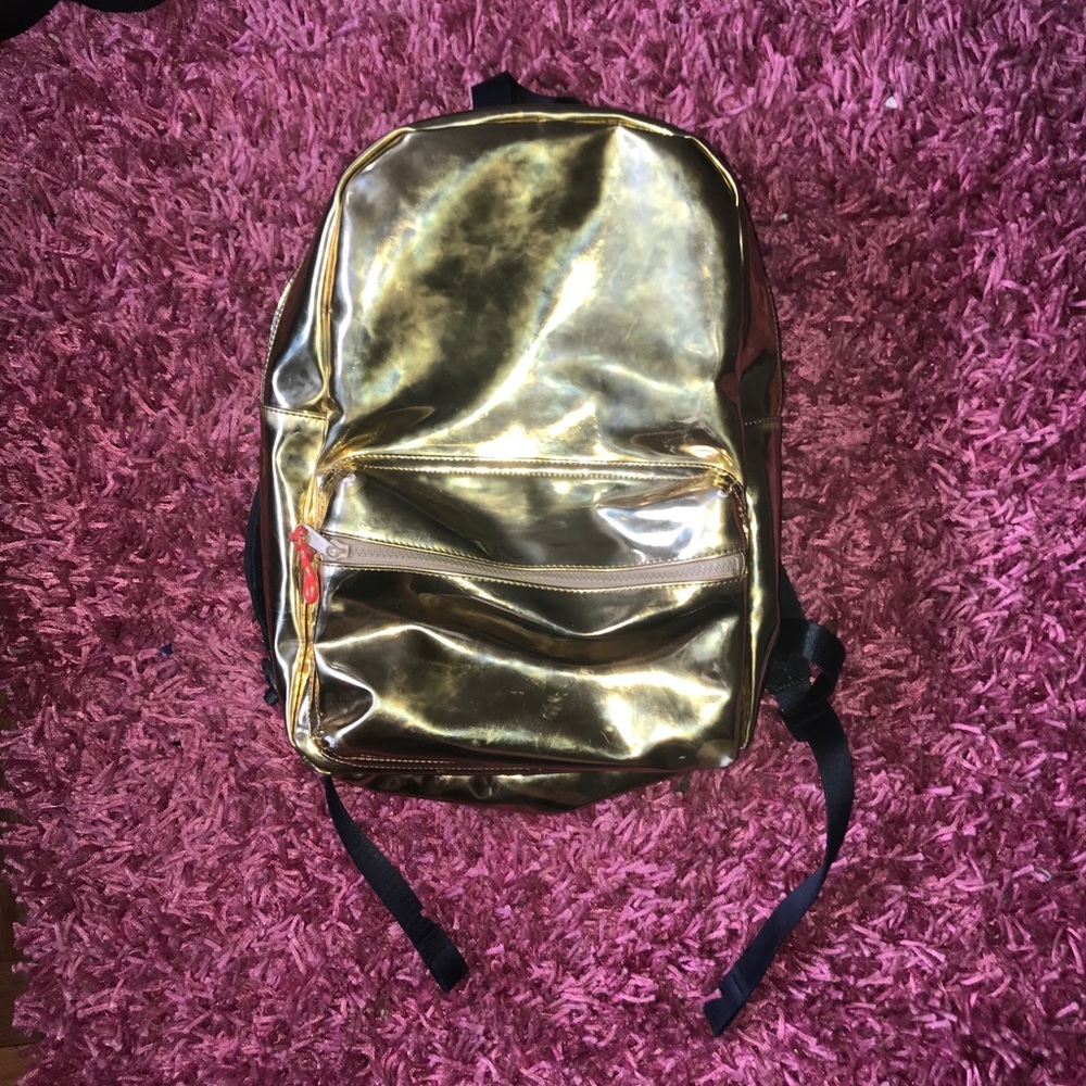 Gold back pack sooo cute can’t throw away